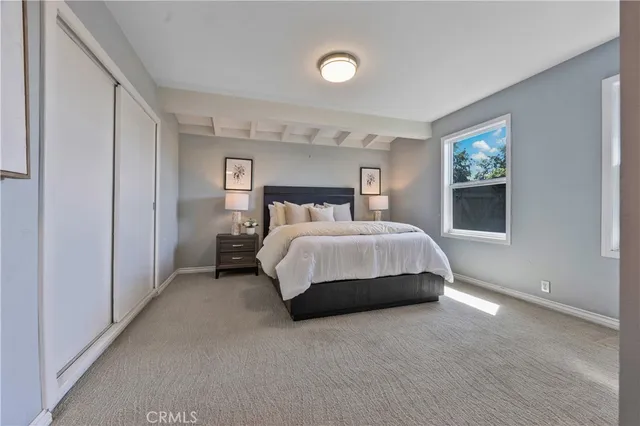 a spacious bedroom with a bed and a window