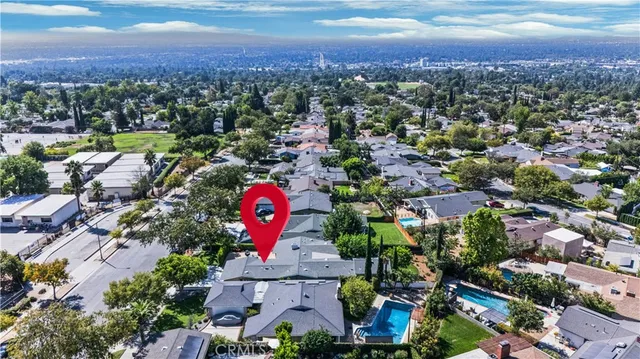 an aerial view of residential house with outdoor space and ocean view