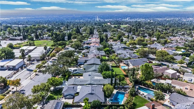 an aerial view of residential houses with outdoor space and river