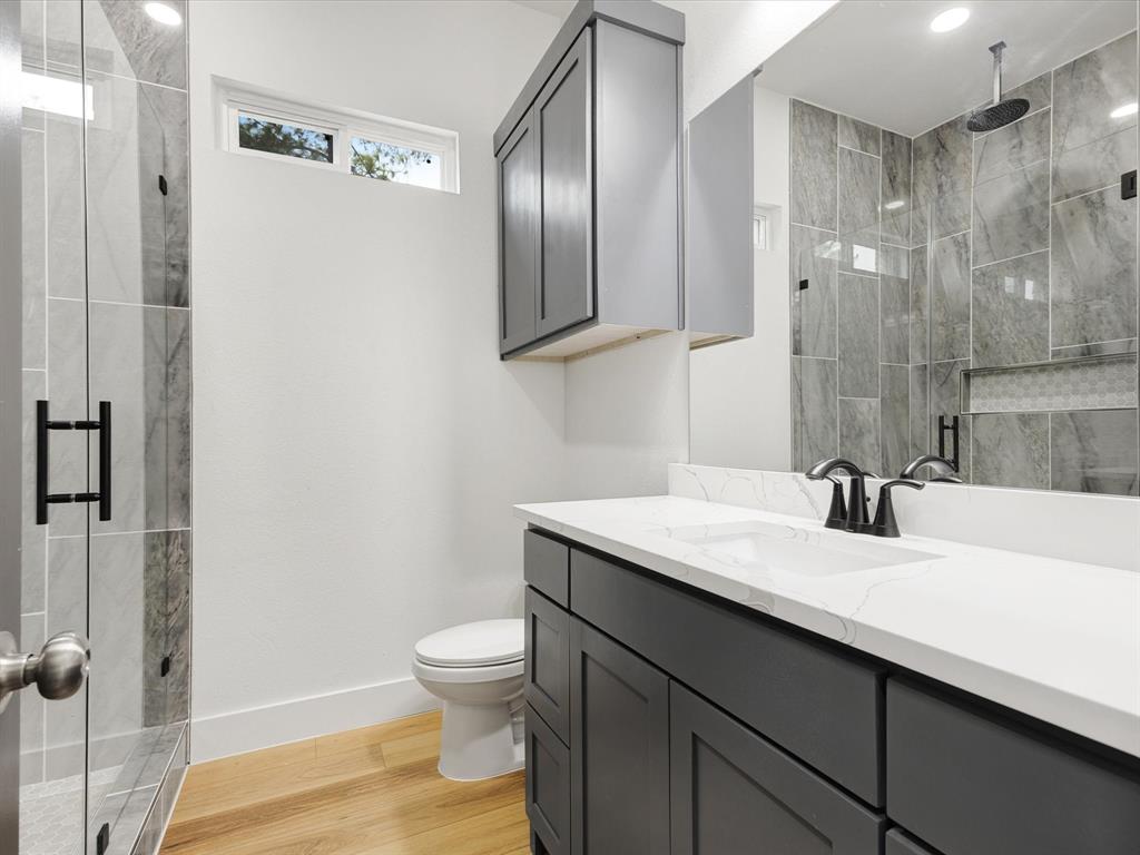 544 Shepherd Road Combine, TX 75159 - Photo 29 of 36 Full bathroom with vanity, a marble finish shower, and light wood-style flooring