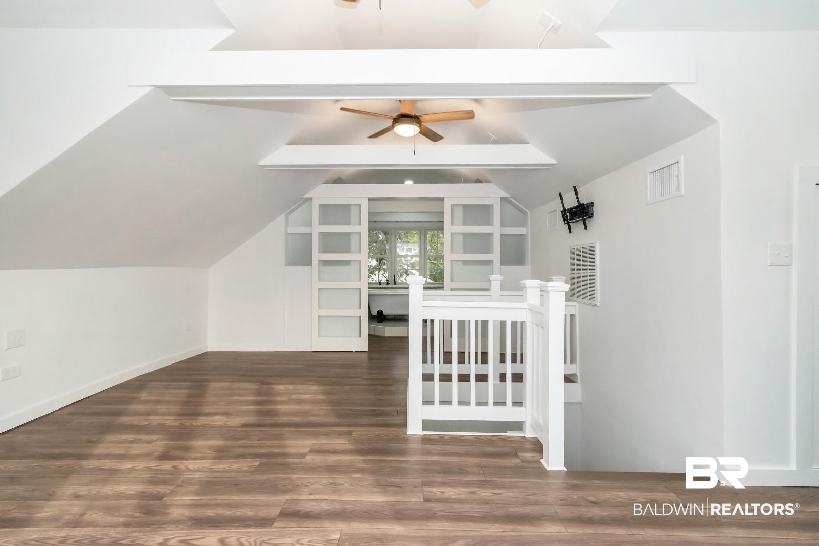2157 Homewood Street Mobile, AL 36606 - Photo 19 of 36 Bonus room featuring ceiling fan, vaulted ceiling, wood finished floors, and visible vents