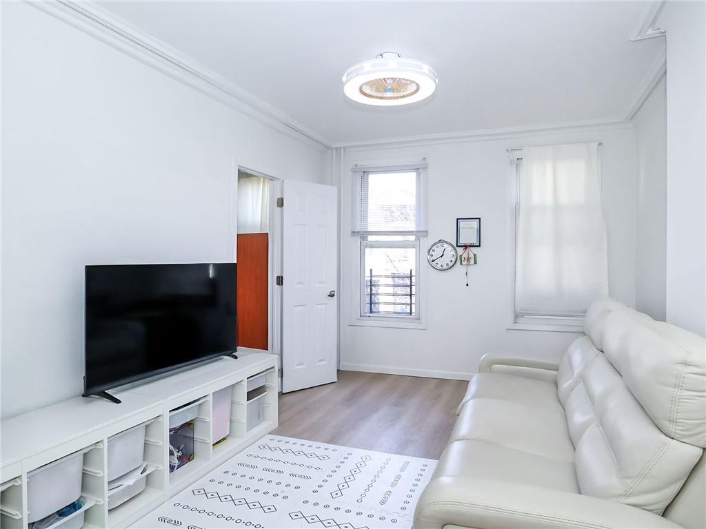 124 Hall Street Brooklyn, NY 11205 - Photo 14 of 31 a living room with a flat screen tv and a window