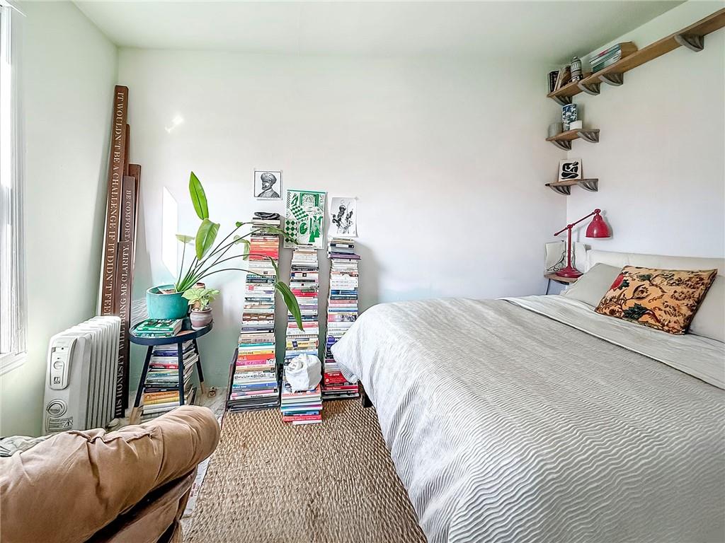124 Hall Street Brooklyn, NY 11205 - Photo 21 of 31 a bedroom with furniture and a wooden floor