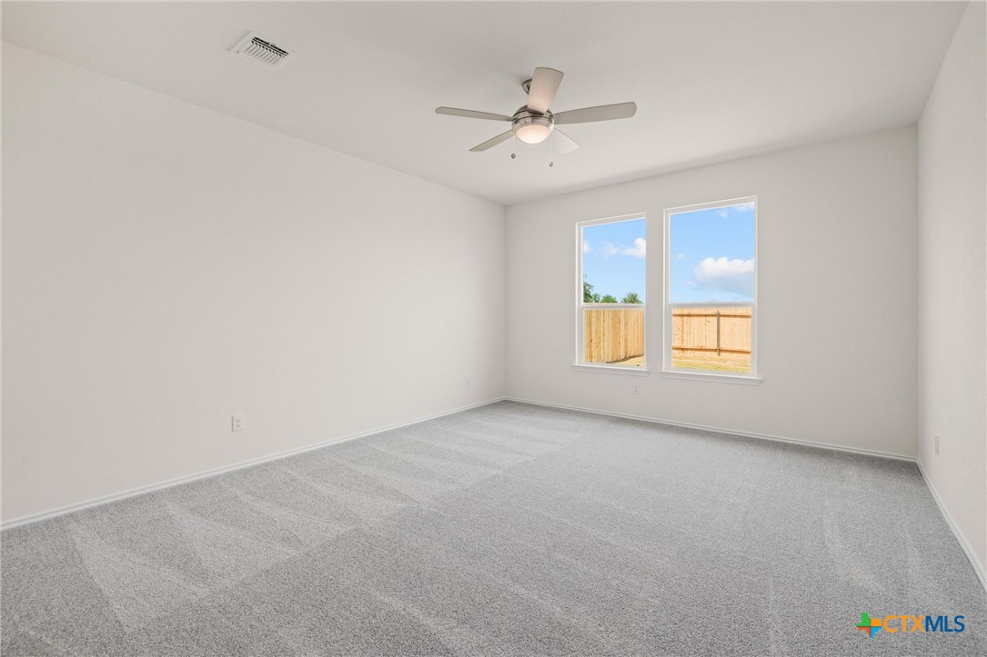 722 Ryan Street Belton, TX 76513 - Photo 15 of 37 Primary bedroom features plush carpeting