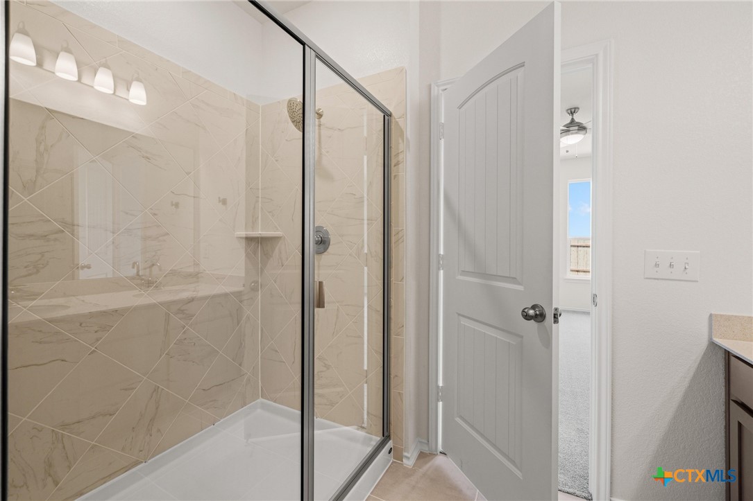 722 Ryan Street Belton, TX 76513 - Photo 18 of 37 Walk-in shower with tile surround