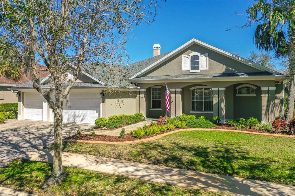 10 North Park Circle Palm Coast, FL 32137 - Photo 1 of 1 a front view of a house with a yard and potted plants