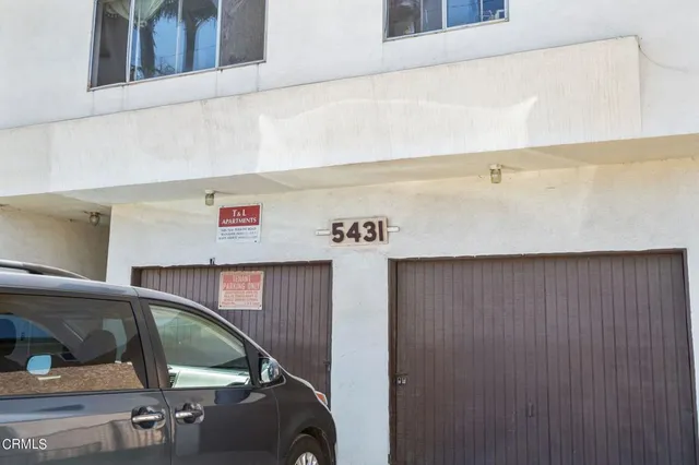 a view of a car park in front of house