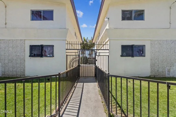 a view of a hallway with wooden floor and stairs