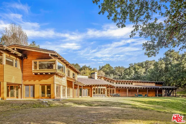 a front view of a residential apartment building with a yard