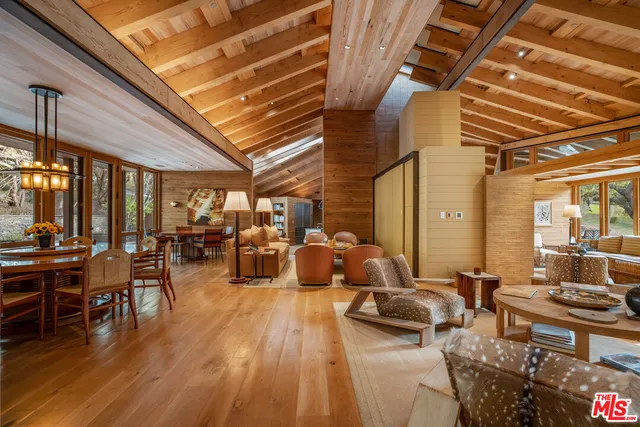 a living room with lots of furniture and large window