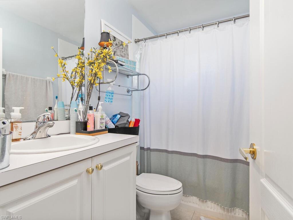 21695 Windham Run Estero, FL 33928 - Photo 13 of 42 a bathroom with a sink a toilet and shower curtain