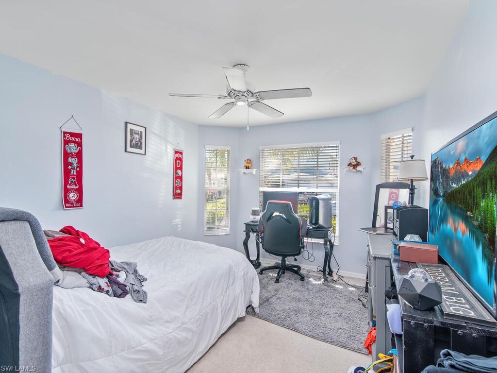 21695 Windham Run Estero, FL 33928 - Photo 14 of 42 a bedroom with a bed and a flat screen tv