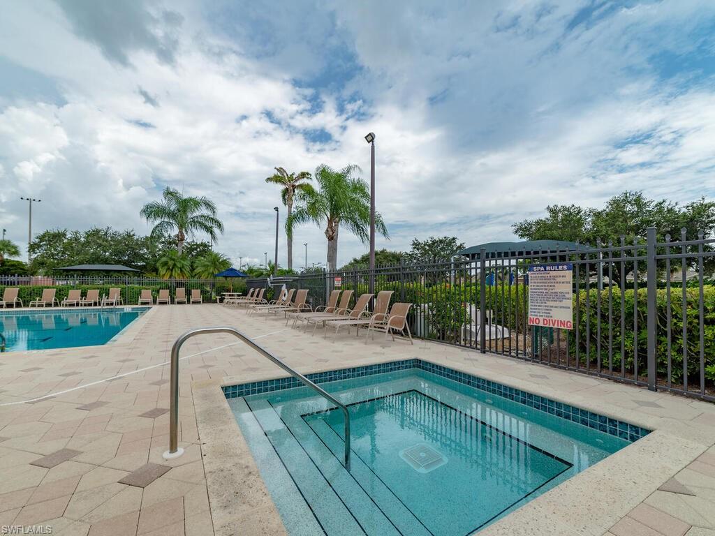 21695 Windham Run Estero, FL 33928 - Photo 32 of 42 a swimming pool with outdoor seating and plants