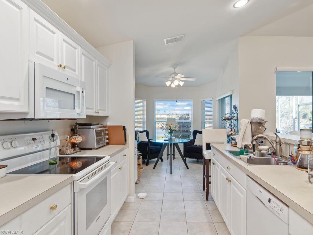 21695 Windham Run Estero, FL 33928 - Photo 6 of 42 a large white kitchen with lots of counter top space