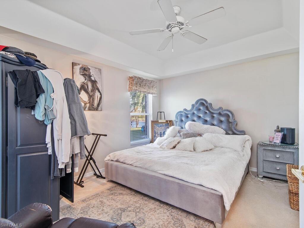 21695 Windham Run Estero, FL 33928 - Photo 9 of 42 a bedroom with a bed and a walk in closet