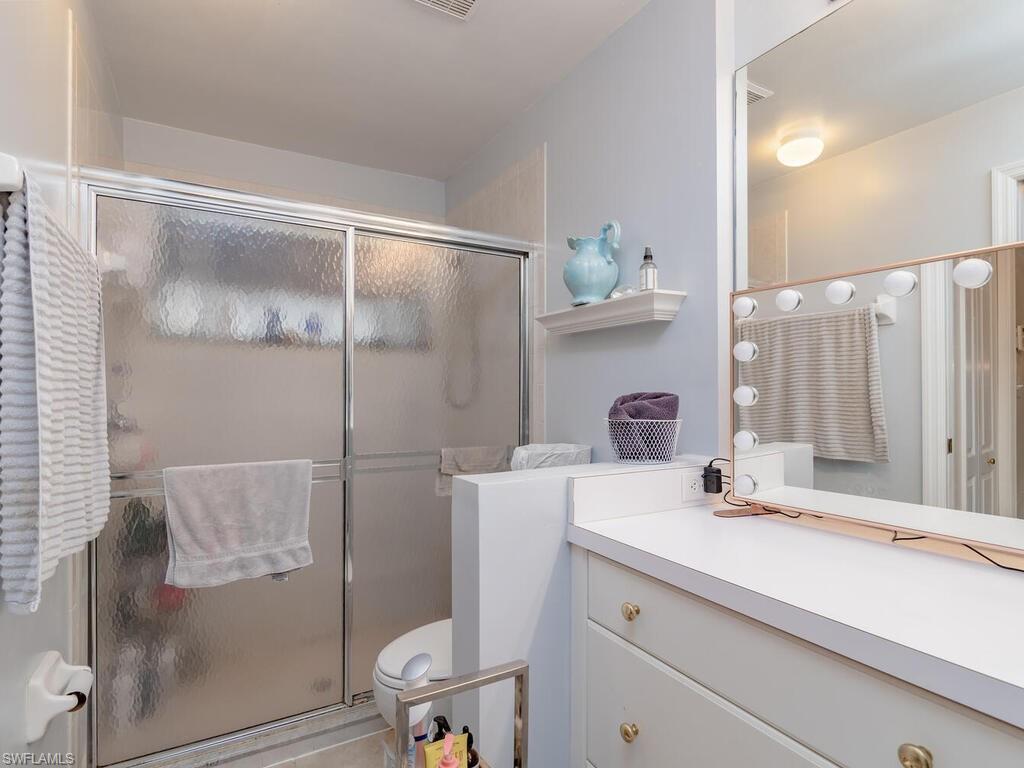 21695 Windham Run Estero, FL 33928 - Photo 10 of 42 a bathroom with a sink mirror toilet and shower