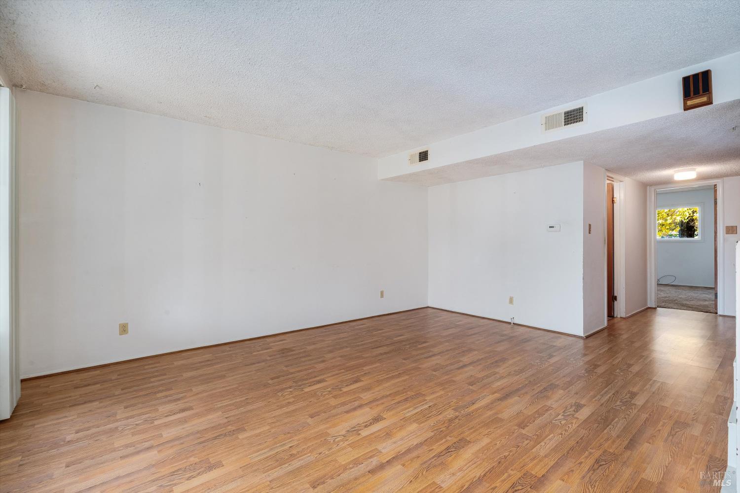 5158 Parkhurst Drive Santa Rosa, CA 95409 - Photo 11 of 40 a view of an empty room with wooden floor