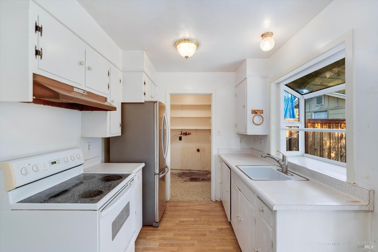 5158 Parkhurst Drive Santa Rosa, CA 95409 - Photo 12 of 40 a kitchen with a sink stove and refrigerator