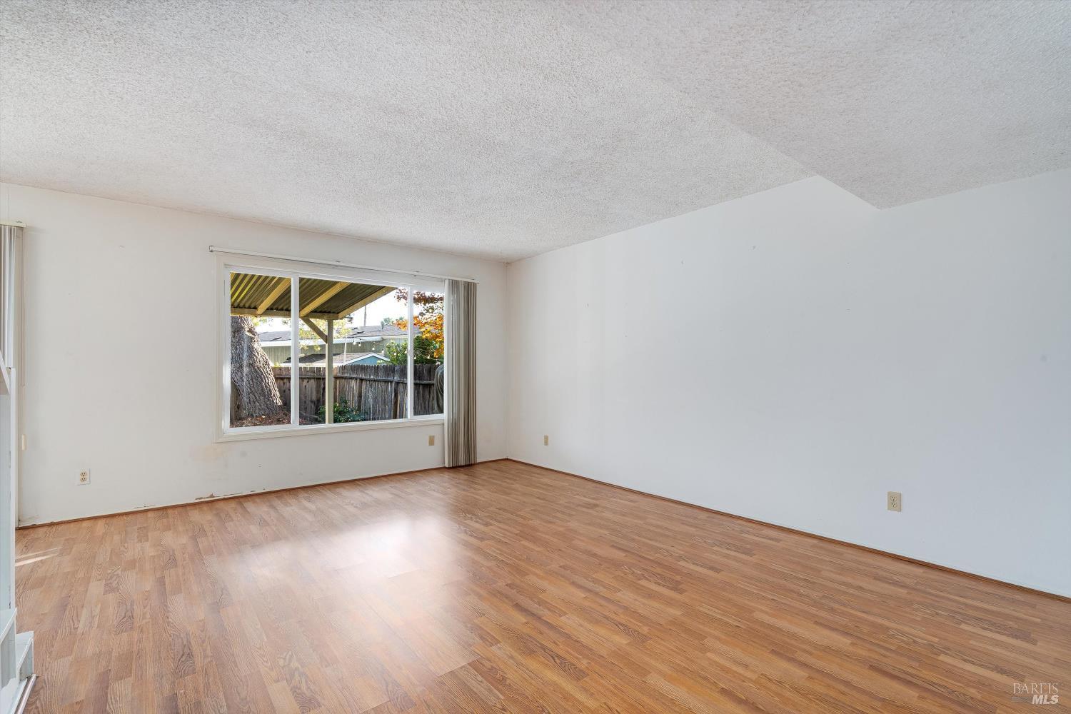 5158 Parkhurst Drive Santa Rosa, CA 95409 - Photo 7 of 40 a view of an empty room with wooden floor and a window