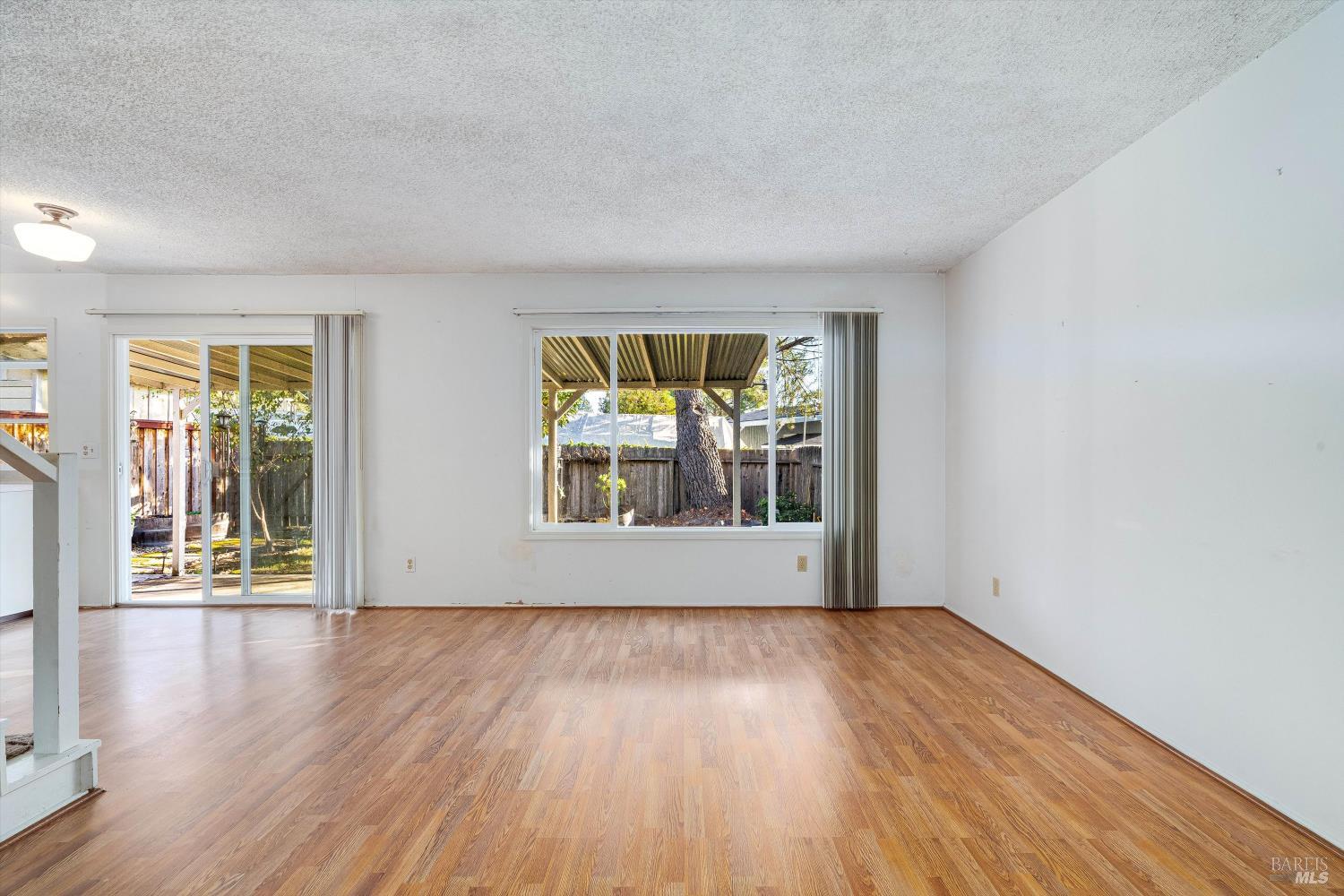 5158 Parkhurst Drive Santa Rosa, CA 95409 - Photo 8 of 40 an empty room with wooden floor and windows