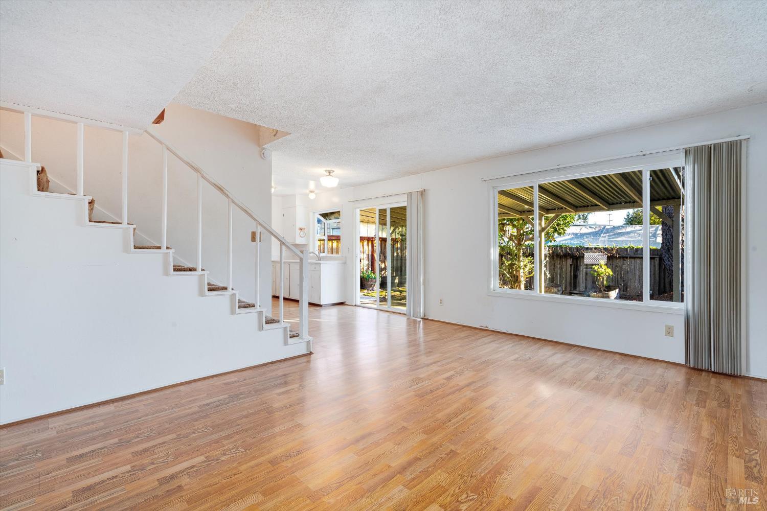 5158 Parkhurst Drive Santa Rosa, CA 95409 - Photo 9 of 40 a view of an empty room with wooden floor and a window