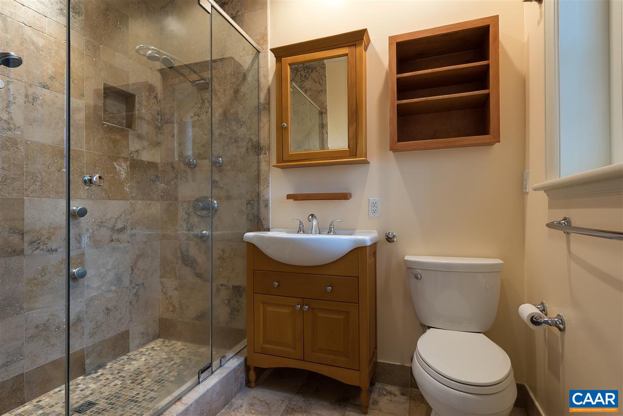 1339 Hilltop Road Charlottesville, VA 22903 - Photo 18 of 24 a bathroom with a granite countertop toilet sink and shower