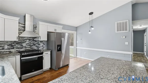a view of a kitchen with a sink and a refrigerator