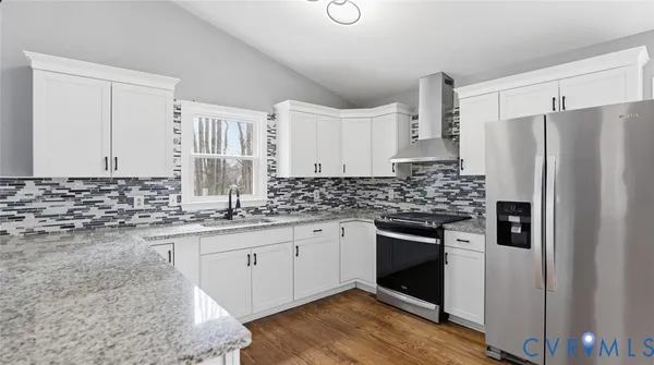 a kitchen with a refrigerator a sink and cabinets