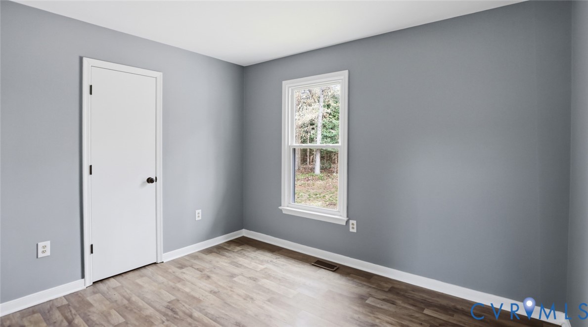 3063 Three Chopt Road Gum Spring, VA 23065 - Photo 19 of 45 an empty room with wooden floor and windows
