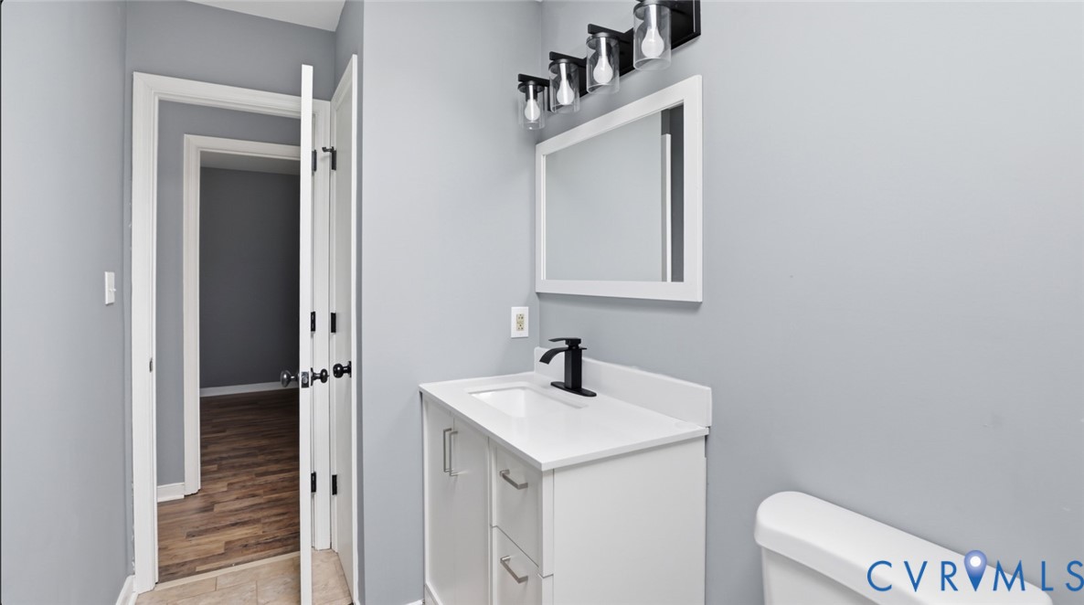 3063 Three Chopt Road Gum Spring, VA 23065 - Photo 21 of 45 a bathroom with a sink a toilet and mirror