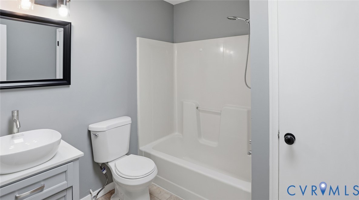 3063 Three Chopt Road Gum Spring, VA 23065 - Photo 27 of 45 a white toilet sitting next to a bathroom sink and a tub