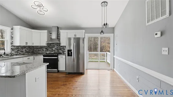 a kitchen with stainless steel appliances a refrigerator and a stove top oven