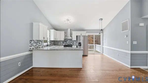 a view of kitchen with wooden floor and window