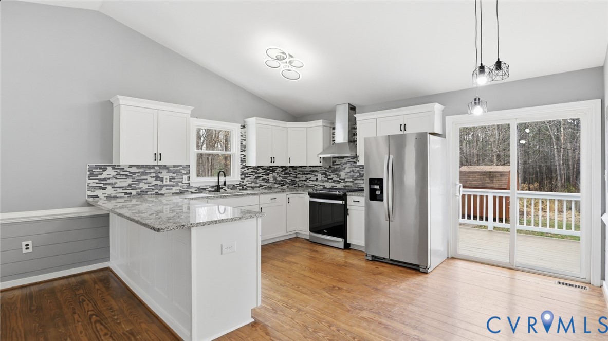 3063 Three Chopt Road Gum Spring, VA 23065 - Photo 8 of 45 a kitchen with kitchen island granite countertop a refrigerator stove top oven and sink
