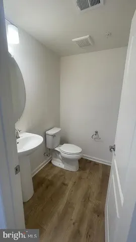a bathroom with a toilet a sink and a mirror