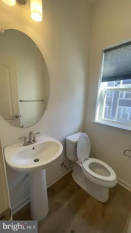 a white toilet sitting next to a bathroom sink