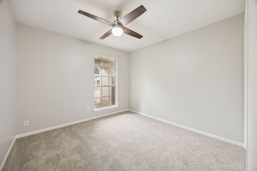 4019 Danpree Street Pasadena, TX 77504 - Photo 12 of 20 an empty room with a window and a fan