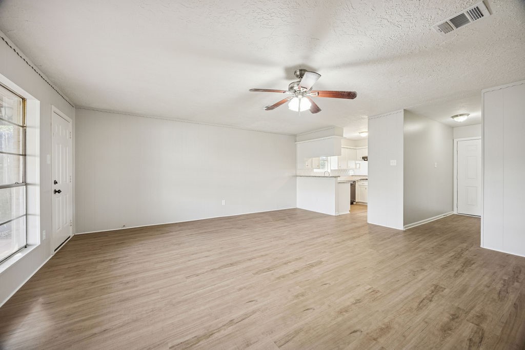 4019 Danpree Street Pasadena, TX 77504 - Photo 4 of 20 a view of a big room with wooden floor and a kitchen