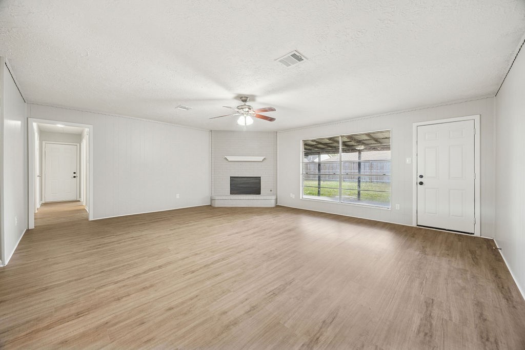 4019 Danpree Street Pasadena, TX 77504 - Photo 7 of 20 a view of a livingroom with wooden floor a ceiling fan and windows