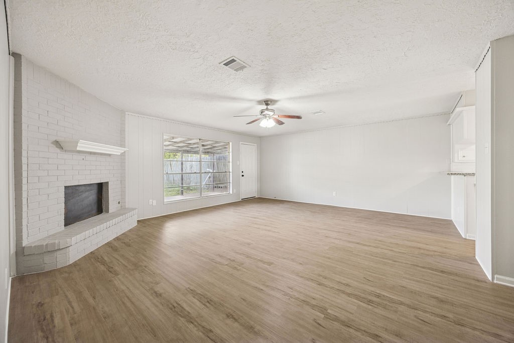 4019 Danpree Street Pasadena, TX 77504 - Photo 8 of 20 a view of an empty room with wooden floor fireplace and a window