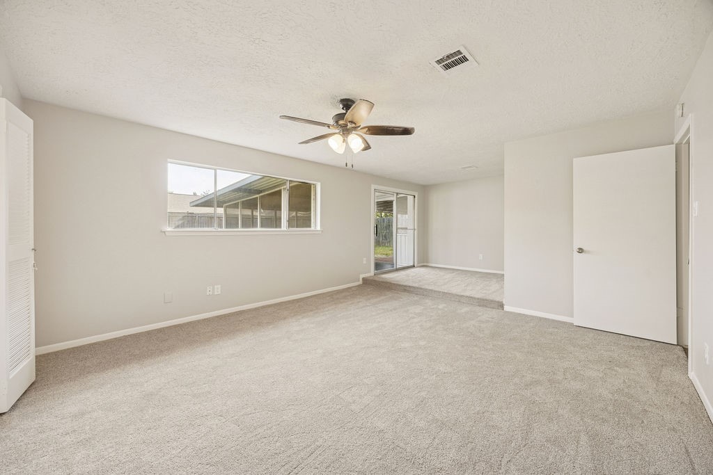 4019 Danpree Street Pasadena, TX 77504 - Photo 10 of 20 a view of a room with a ceiling fan and a window