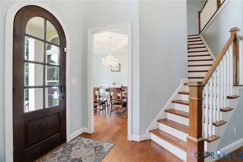 a view of a dining room with furniture large windows and wooden floor