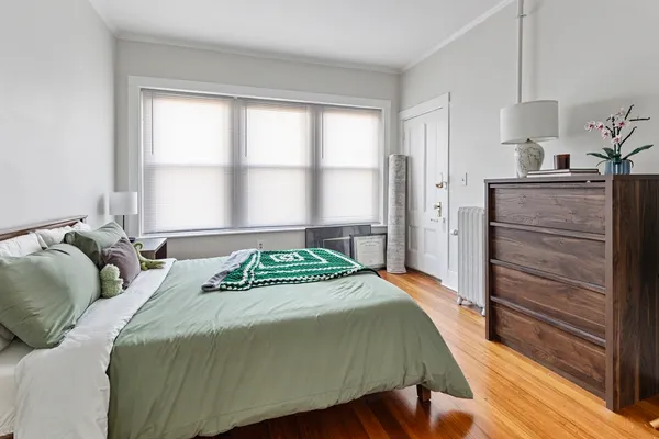 a bedroom with a bed and a window