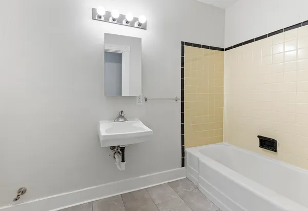 a bathroom with a sink a bathtub and a shower