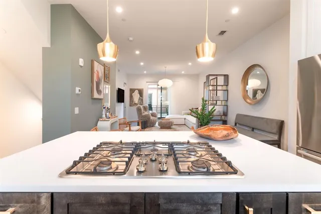 a large kitchen with a table and chairs