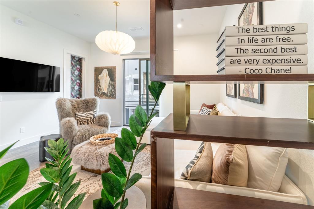13900 Noel Road, Unit 203 Dallas, TX 75240 - Photo 7 of 11 a living room with furniture and a flat screen tv
