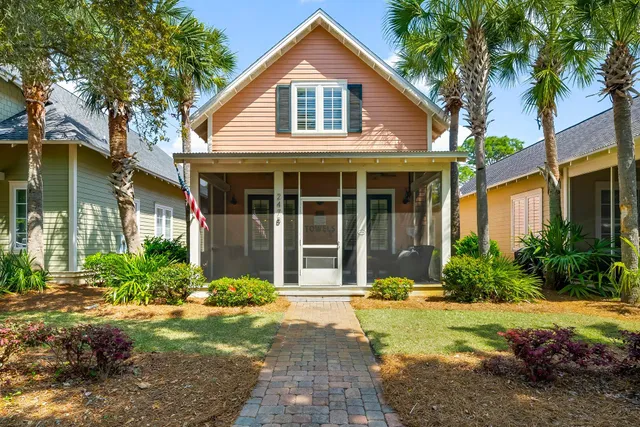 a front view of a house with garden and porch
