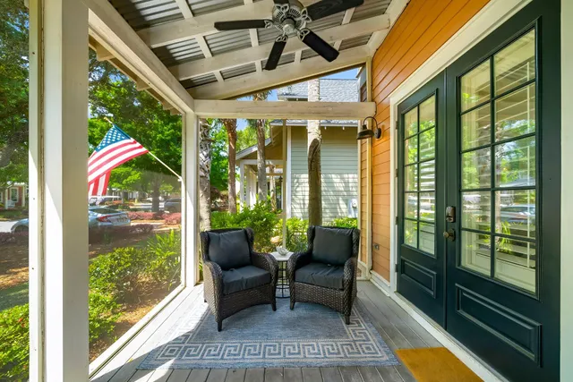 a balcony with furniture and wooden floor