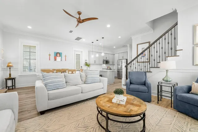 a living room with furniture a rug and a chandelier