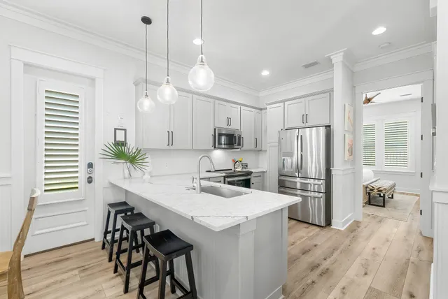 a kitchen with stainless steel appliances granite countertop a sink stove and refrigerator